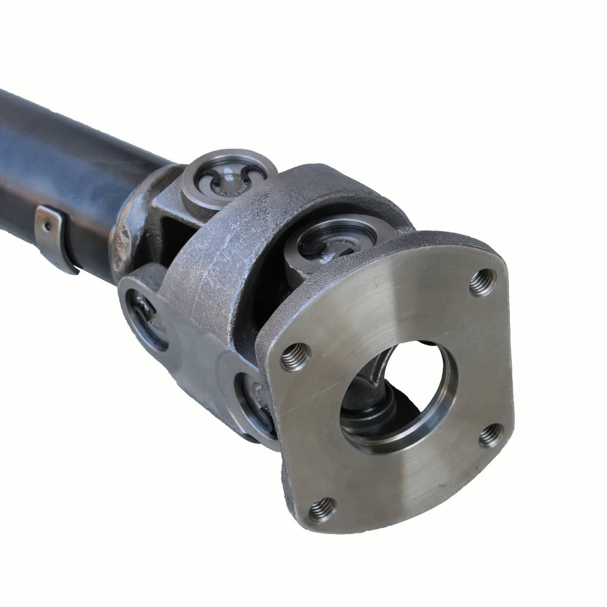Front drive shaft flange yoke with four-bolt mounting holes and U-joint end