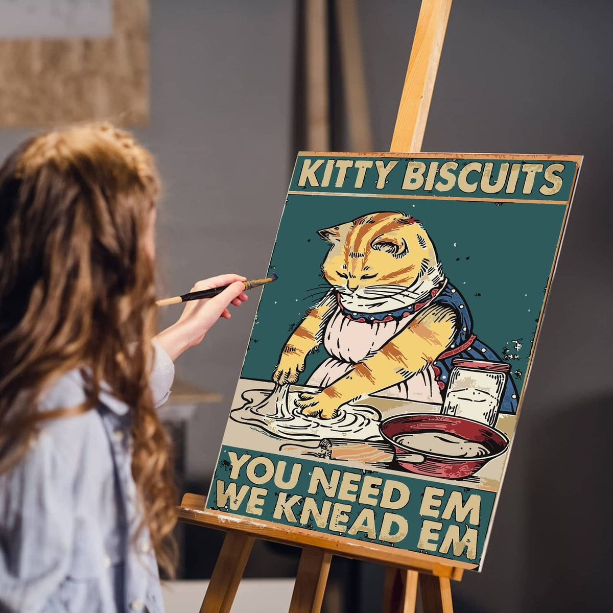 Woman painting a cat paint-by-numbers canvas on an easel with a brush