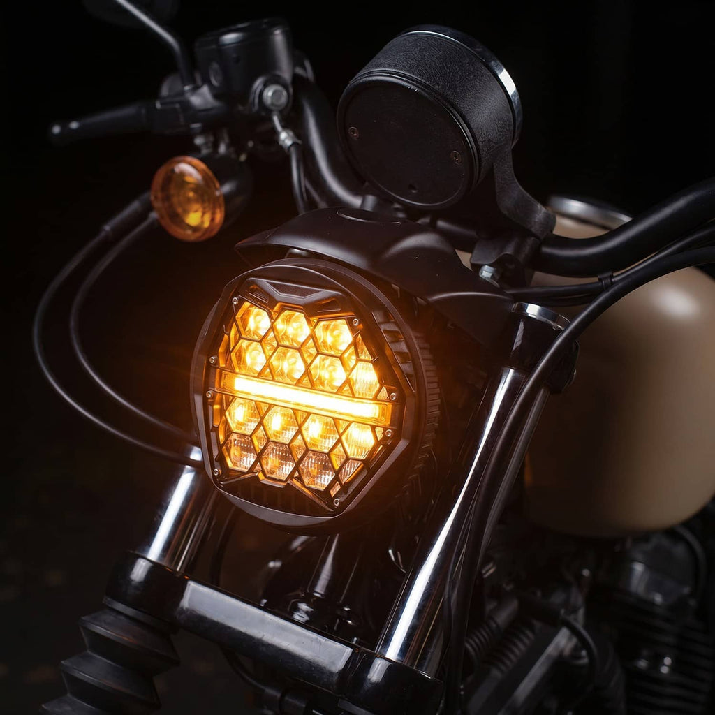 Round LED headlight on a motorcycle, illuminated amber DRL in a crosshatch lens