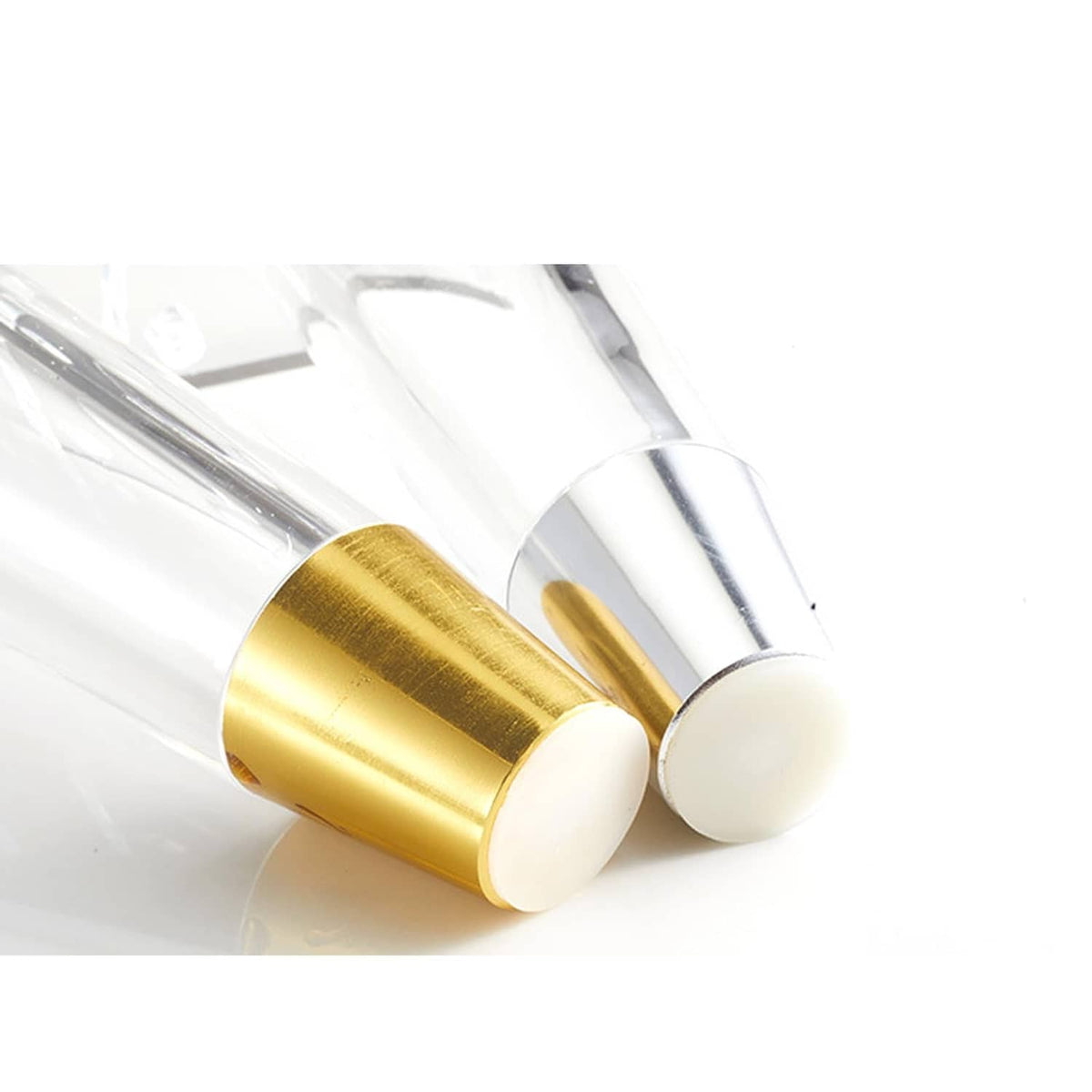 Close-up of clear acrylic table legs with gold bottom sleeves and rounded feet