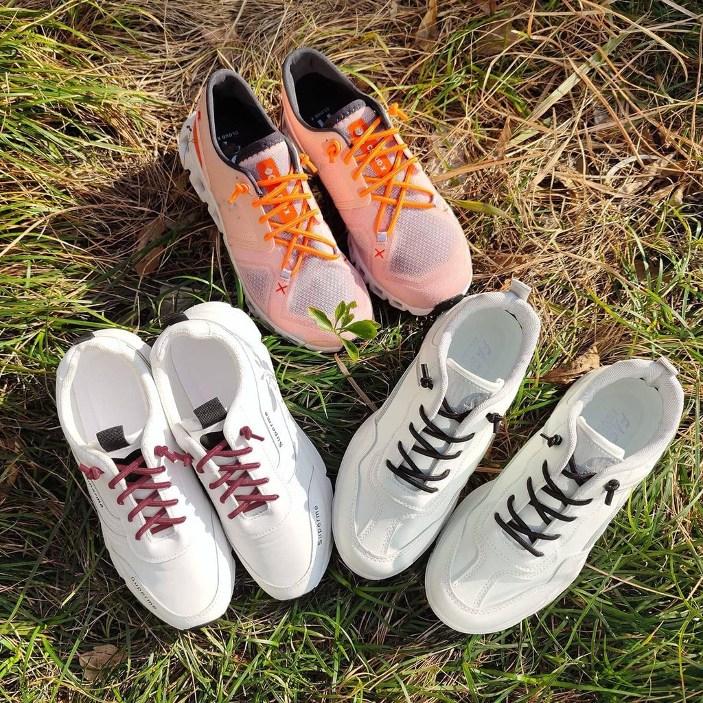 Elastic laces on sneakers in orange, red, black, and gray colors outdoors