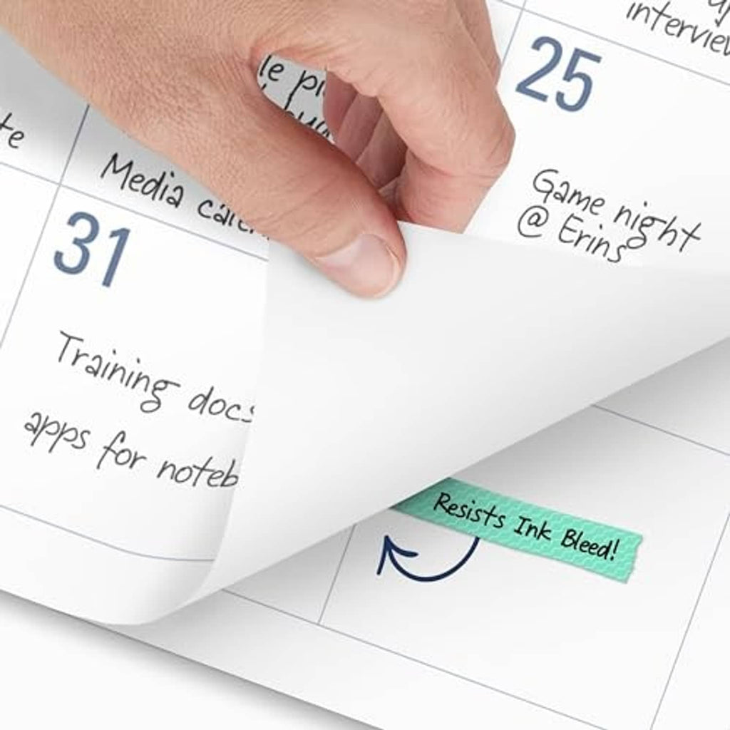 Desk calendar page being peeled back, showing handwritten notes over a date grid
