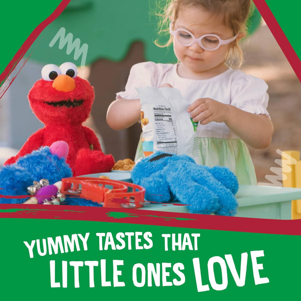 Child examining a snack package with Sesame Street character on table