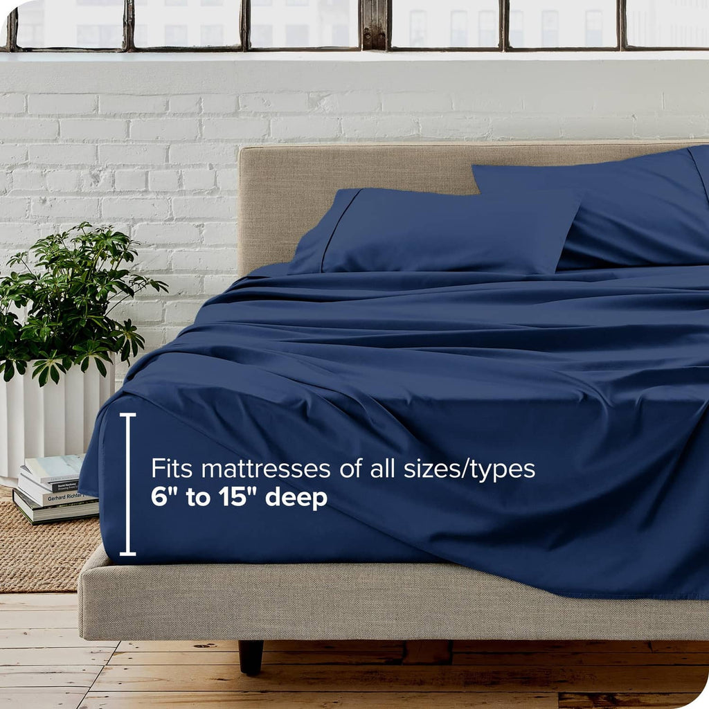 Dark blue full bed sheet set with deep-pocket fitted sheet, shown on a bed