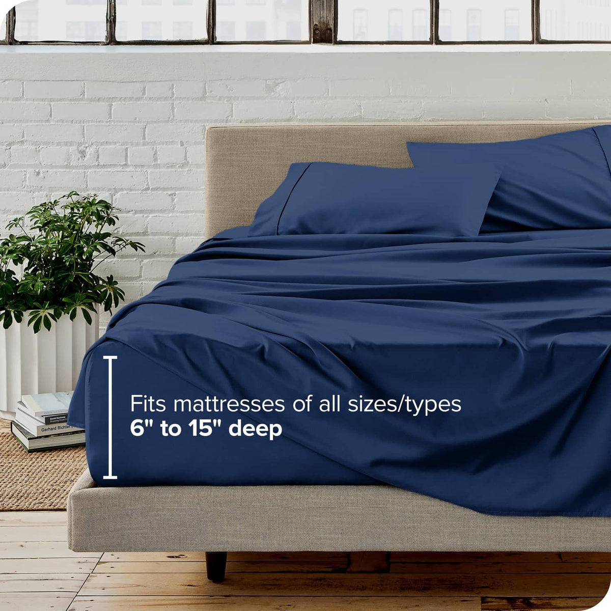 Dark blue full bed sheet set with deep-pocket fitted sheet, shown on a bed
