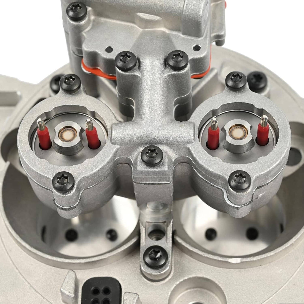 Throttle body assembly close-up of twin throttle chambers and valve hardware, silver.