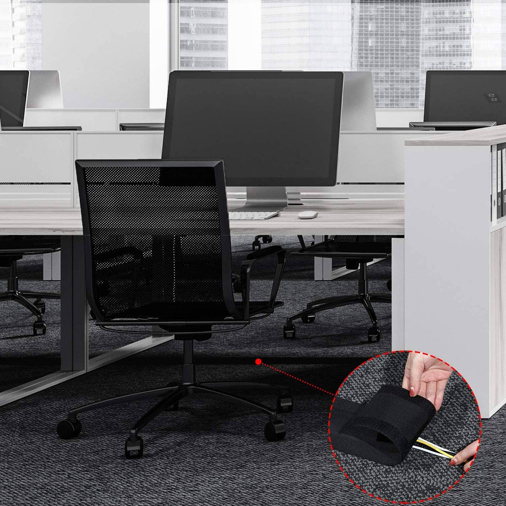 Black carpet cord cover cable protector installed on office carpet with cables routed