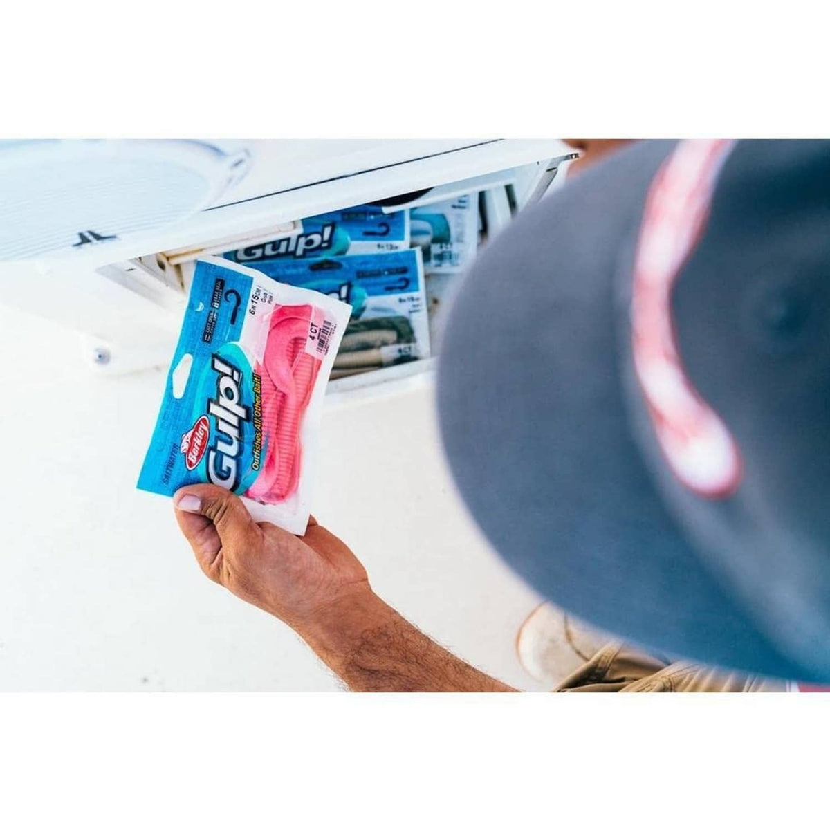 Berkley Gulp soft bait in blue retail pouch held in hand