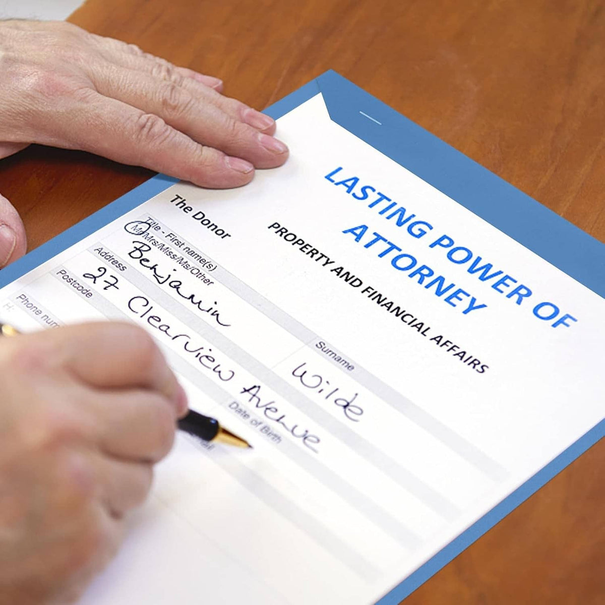 Blue manuscript cover paper being filled by hand with a signed legal form