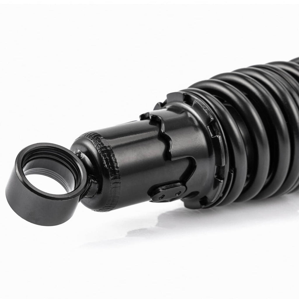 Black rear suspension shock close-up with coiled spring and top mounting ring, threaded end