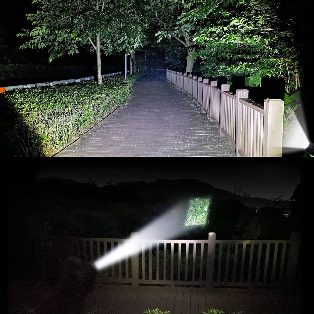 Black LED flashlight shining a wide beam, with glowing green front button