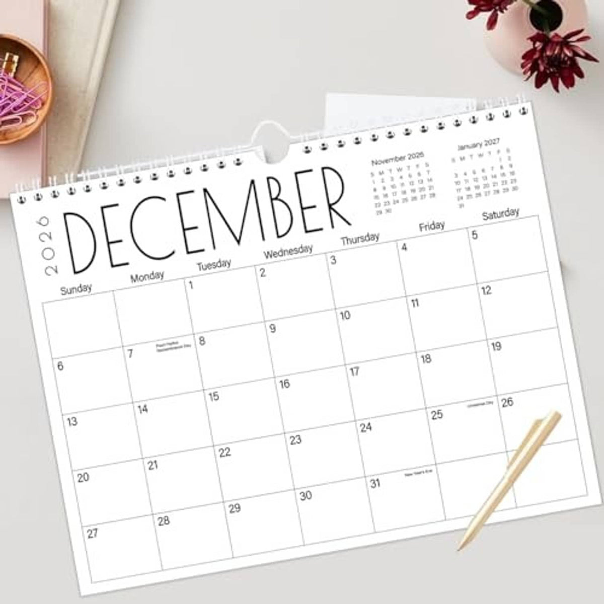 Wall calendar with spiral binding, December 2026 grid and black month title