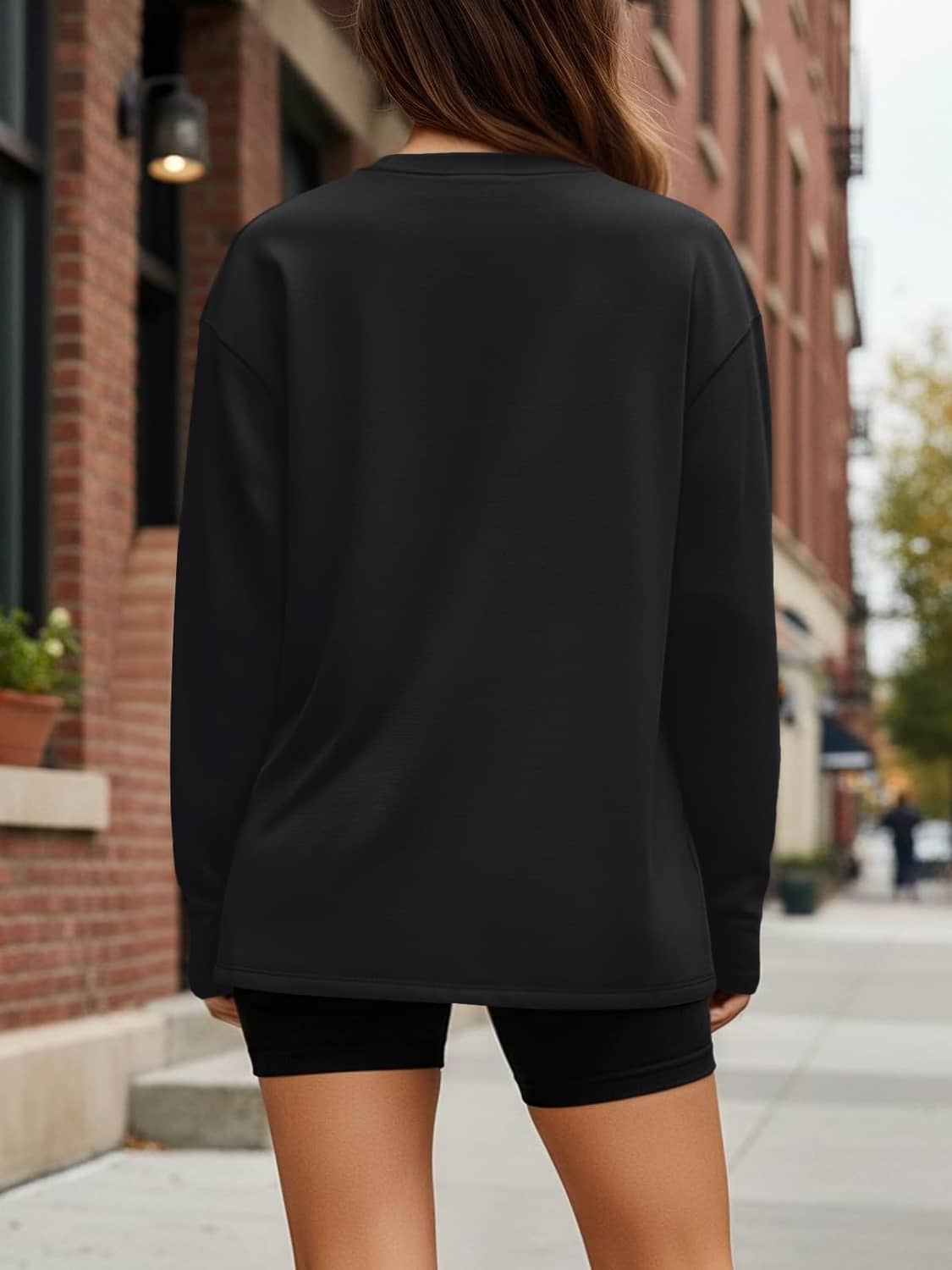 Women’s oversized black long sleeve T-shirt from the back, crew neck and long sleeves