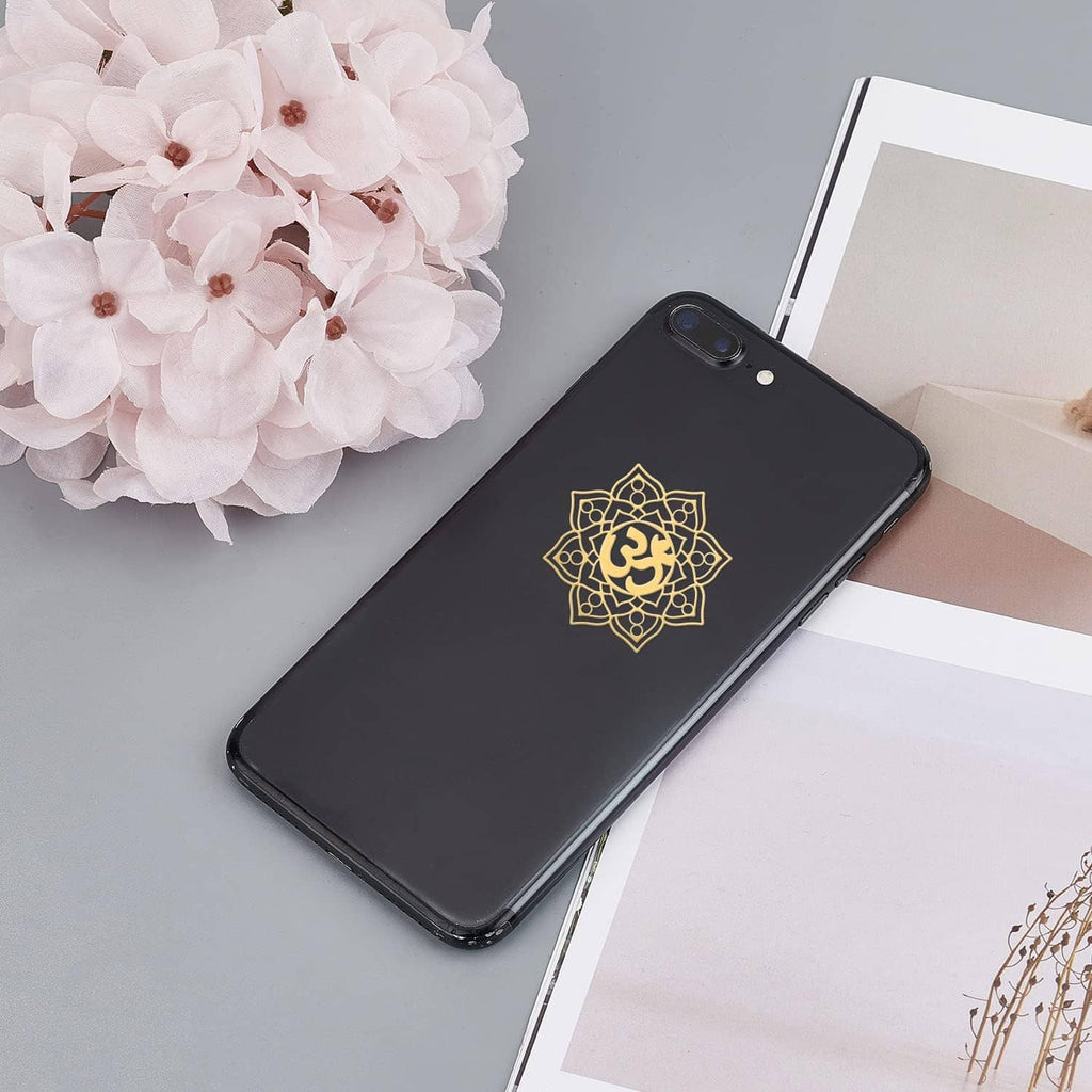Gold chakra mandala sticker on a black phone case