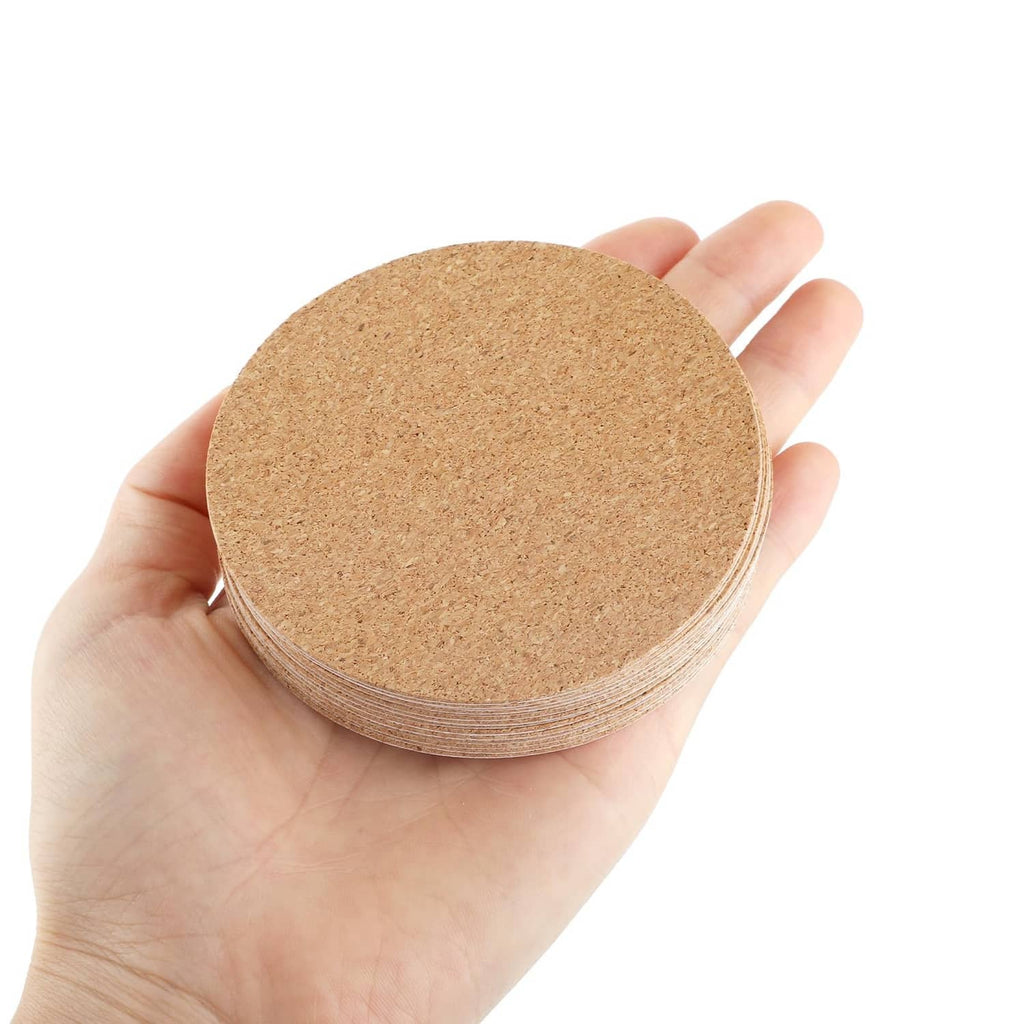 Hand holding a stack of self-adhesive cork round coaster sheets