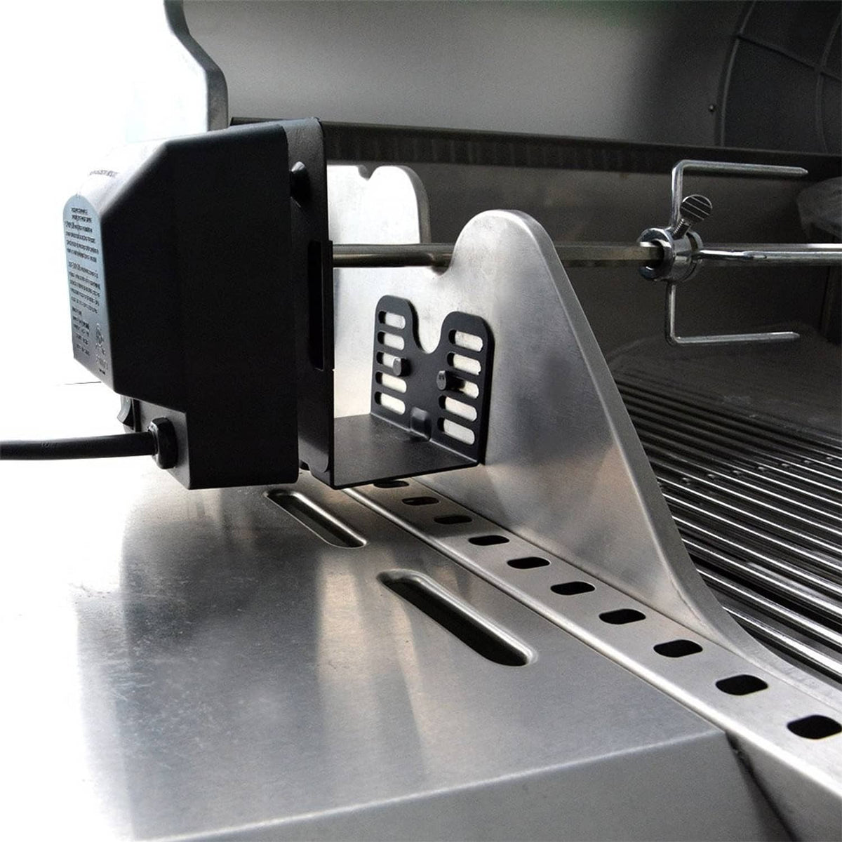 Rotisserie motor bracket on barbecue grill with stainless spit and front access plate
