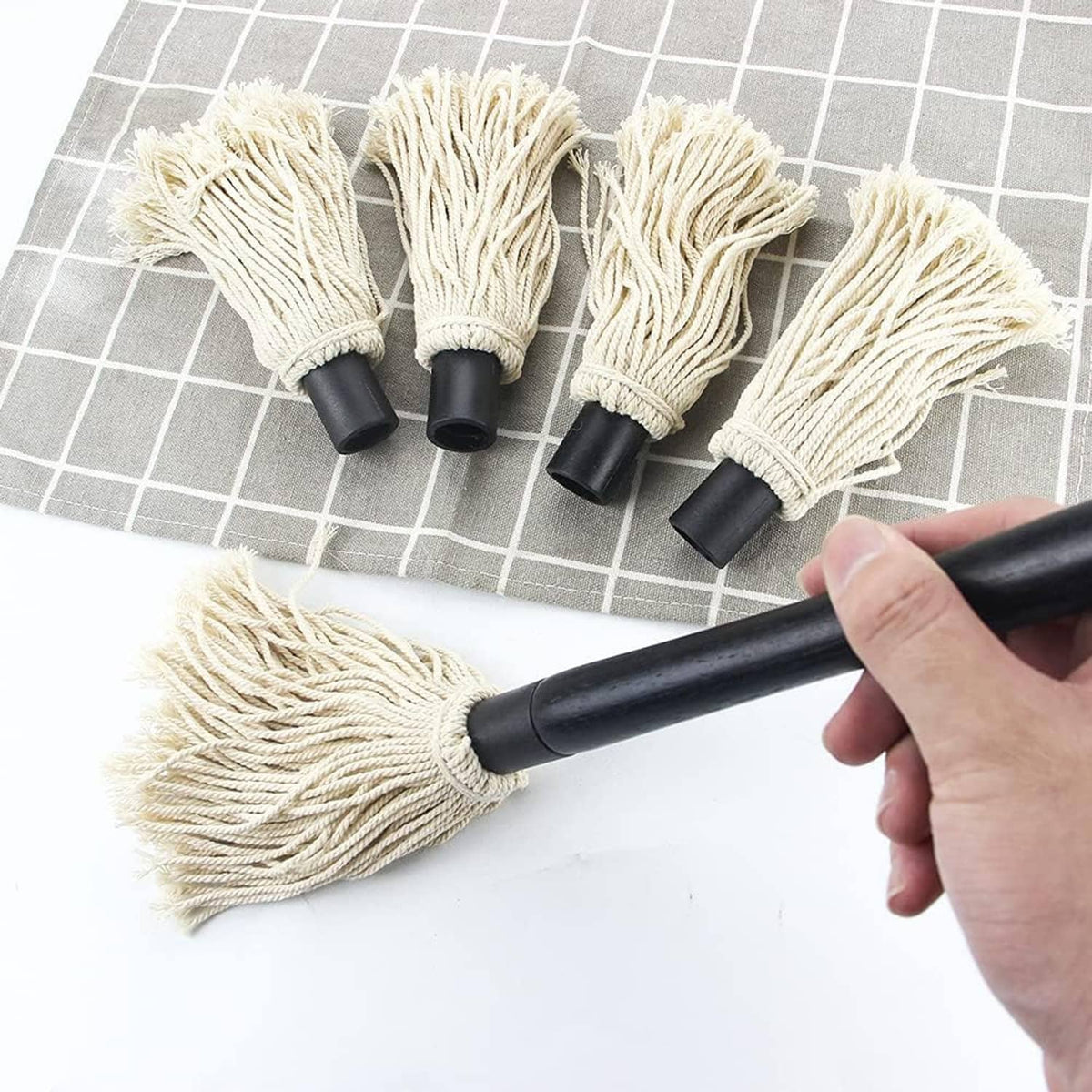 Grill basting mop handle with cream cotton tassel brush heads shown in use