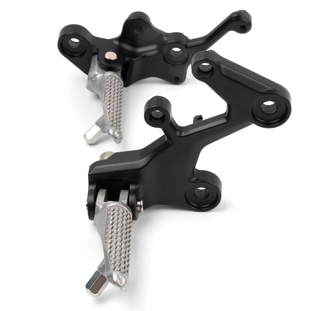 Close-up of black footpeg brackets with textured silver pegs and visible mounting points