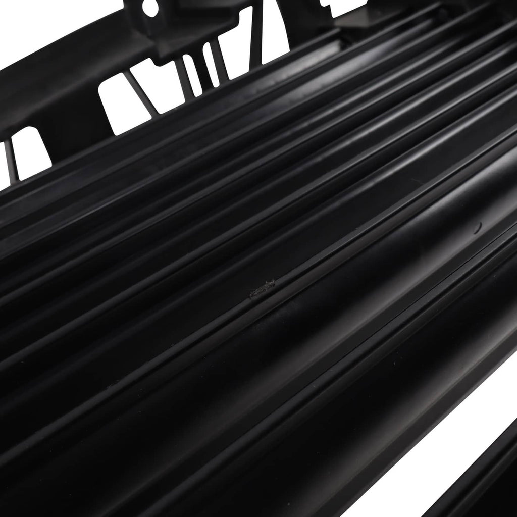 Close-up of black upper grille air shutter slats and slat frame edges