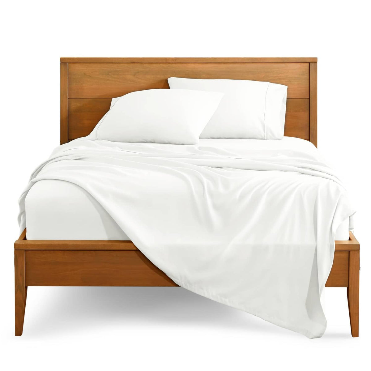 Cream bed sheet set with fitted and flat sheets, draped neatly on a bed