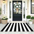 Black-and-white striped area rug placed at a front door entryway.