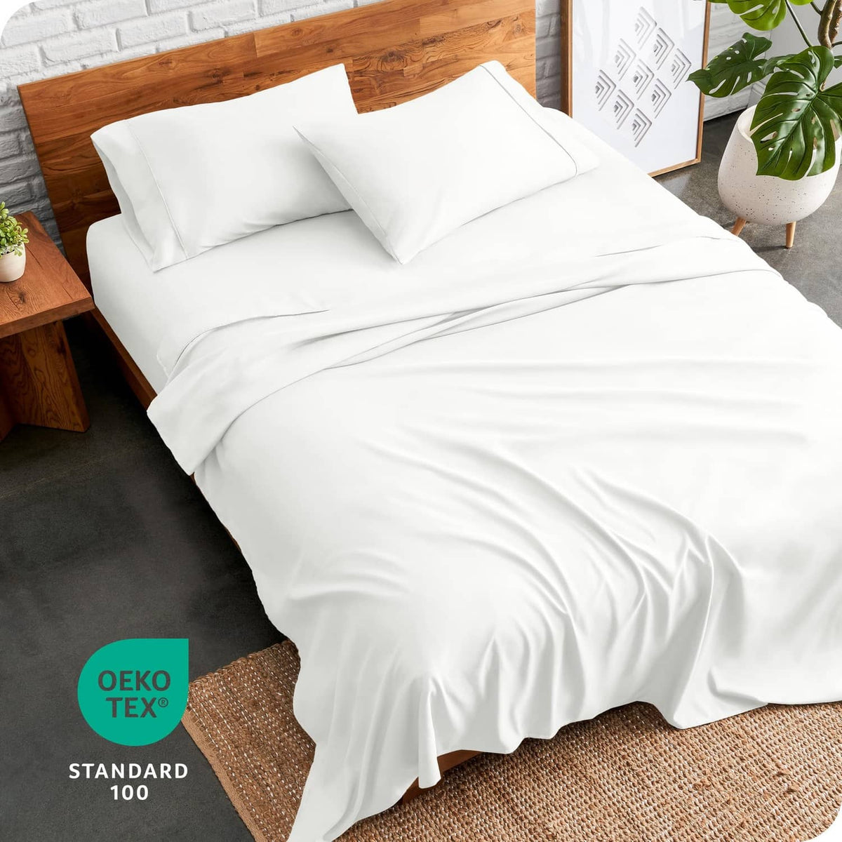 Cream bed sheet set with fitted sheet draped over the mattress on a bed