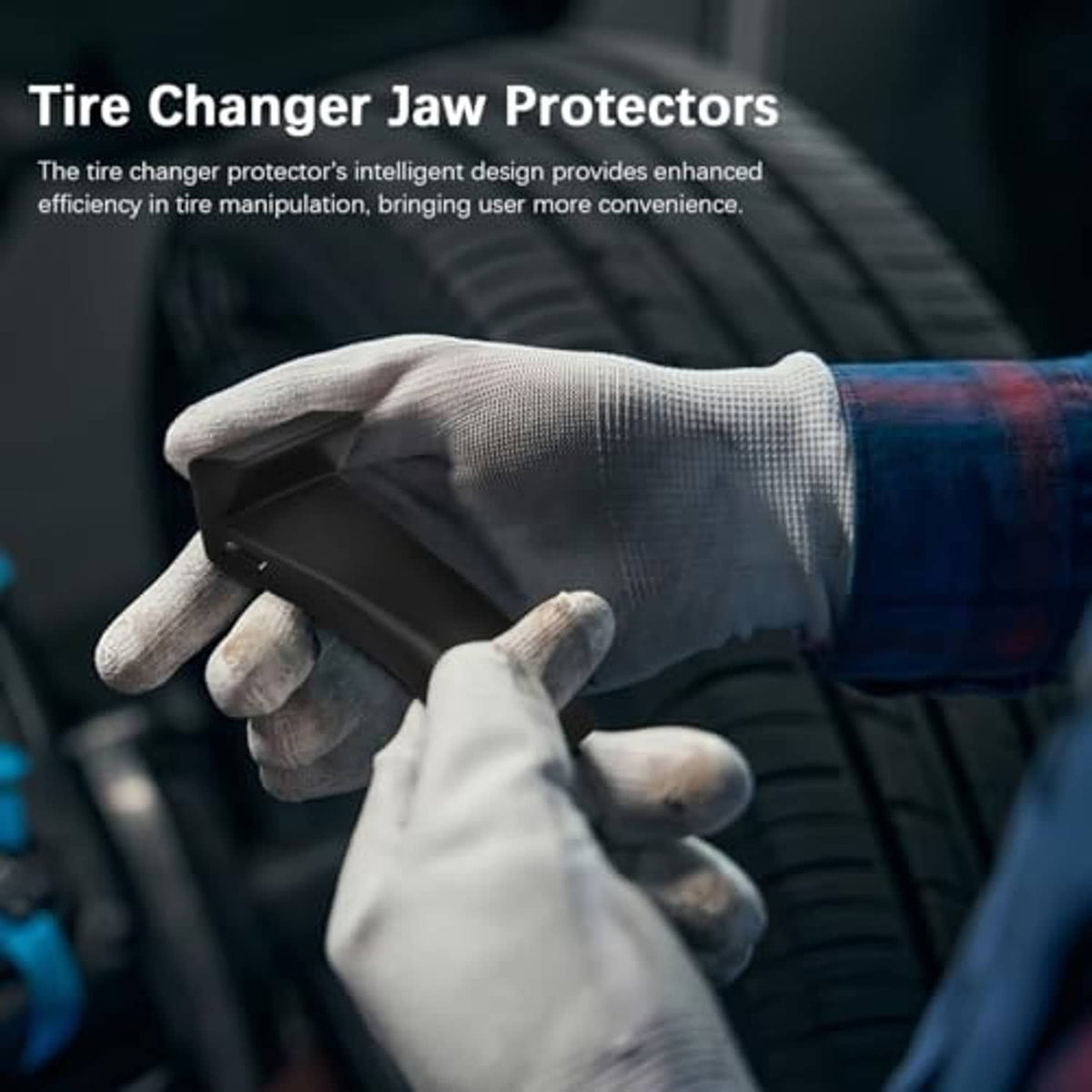 Black tire changer jaw protector held in gloved hand, protective clamp cover.
