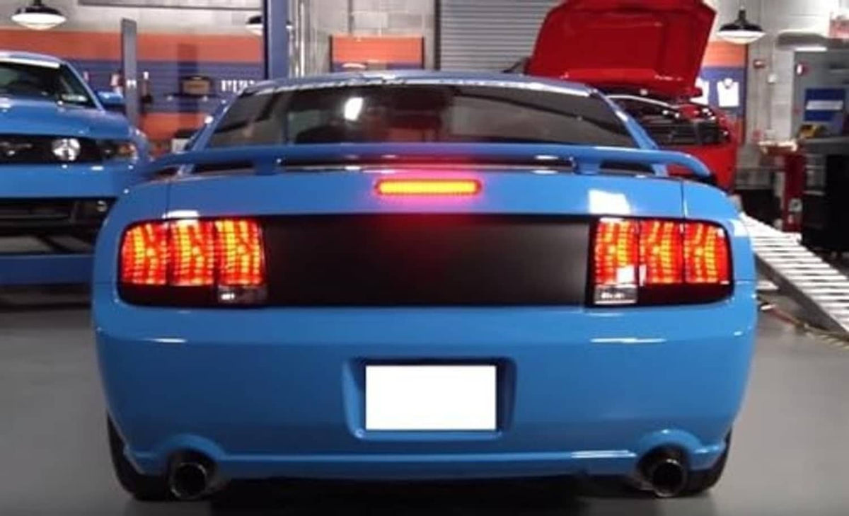 Installed LED third brake light bar on rear trunk, red illuminated through smoked lens