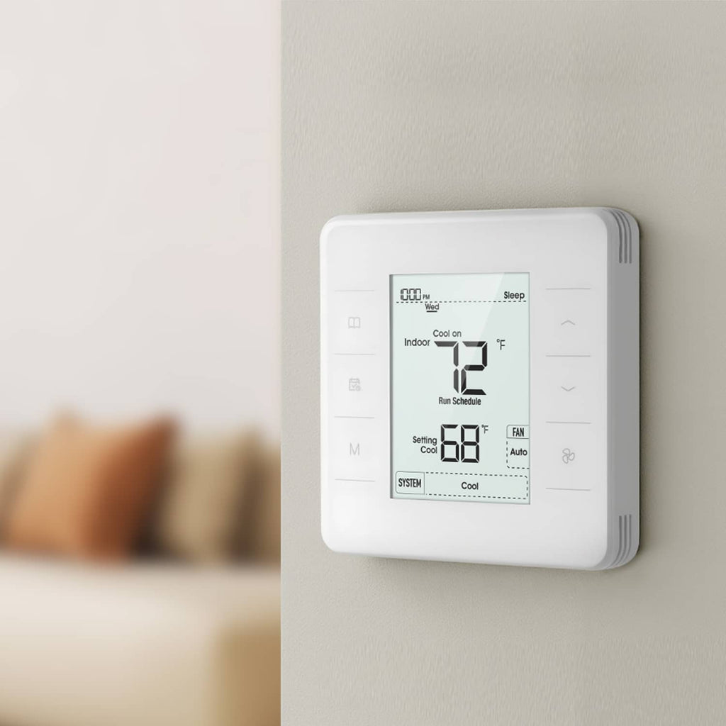 White programmable thermostat mounted on wall with digital screen and controls