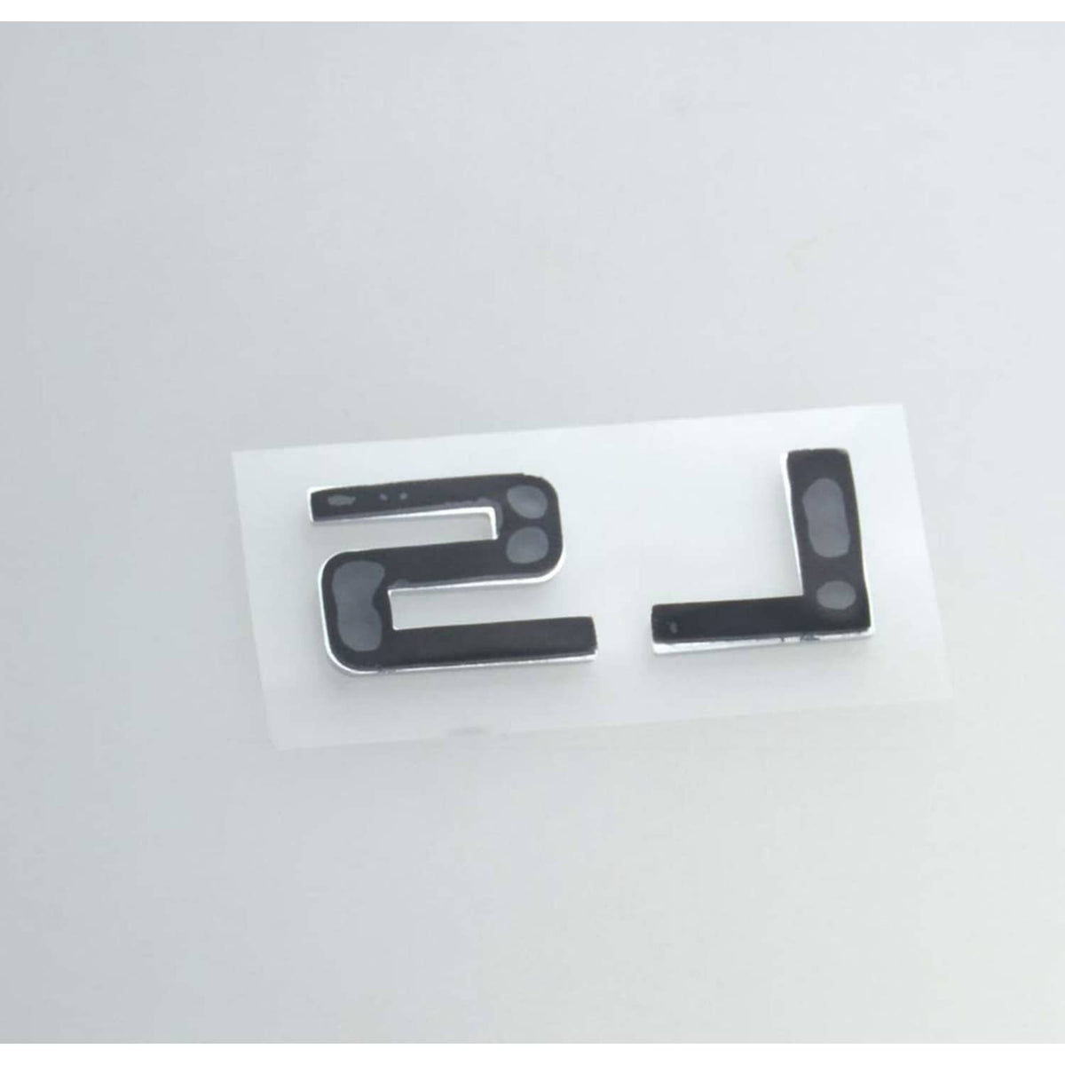 Gloss black LS emblem badges with chrome-edged backs on white backing.