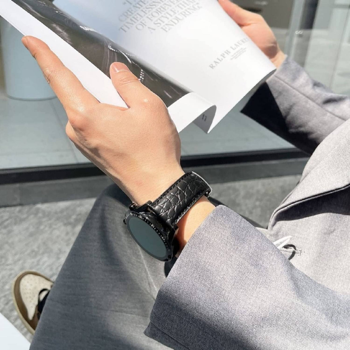 Black crocodile leather watch strap on wrist, quick-release buckle visible