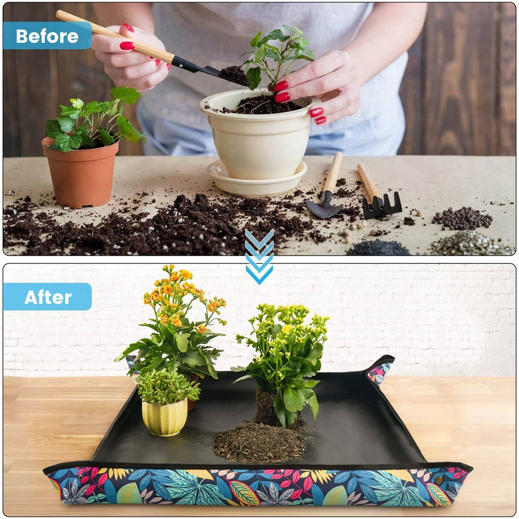 Black repotting tray with colorful leaf print border, holding soil and small planters