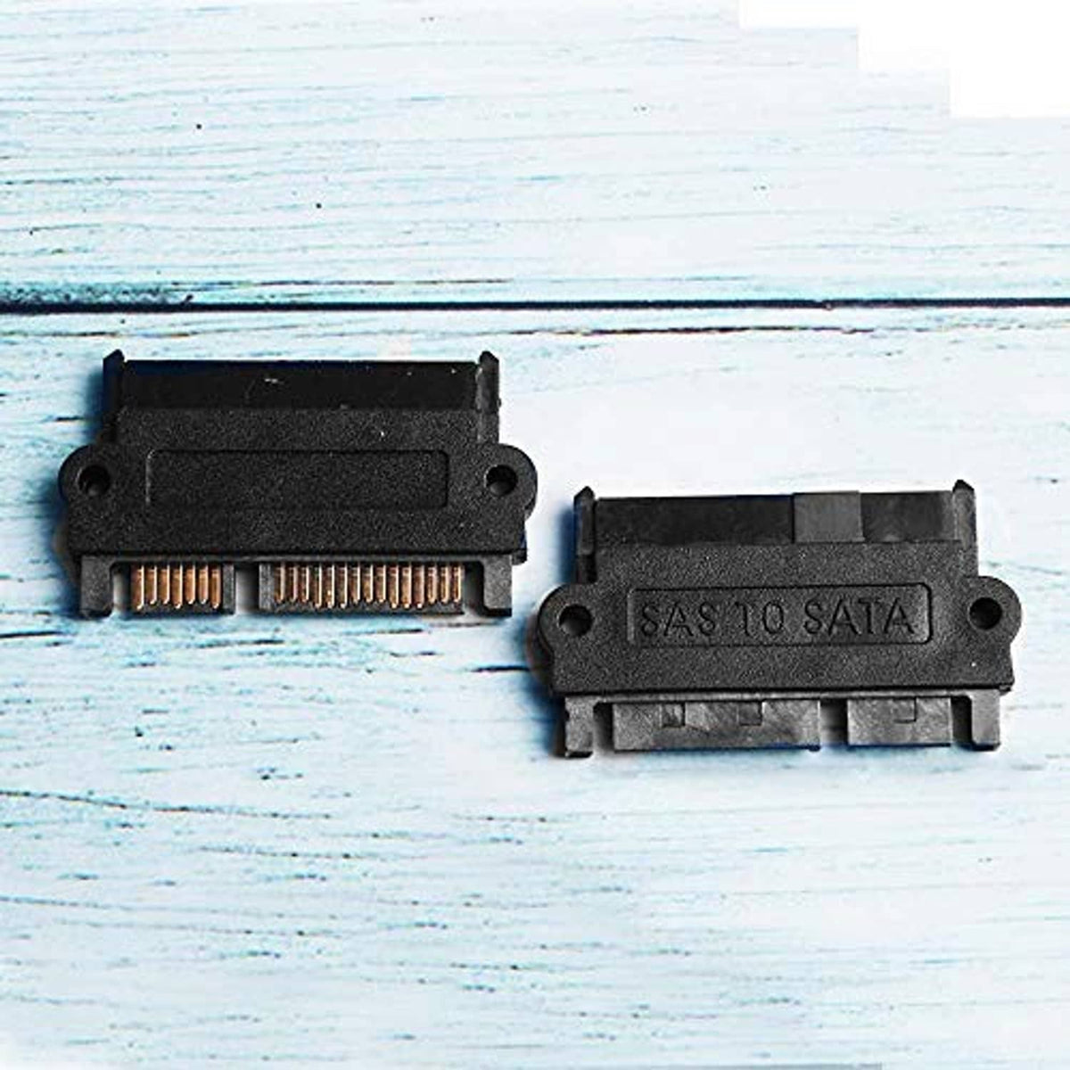SAS to SATA hard drive adapter pair with gold contact strips, black housings