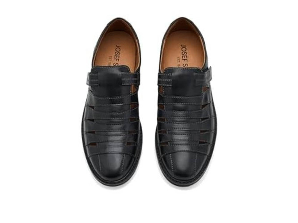Pair of black leather casual shoes with open interior lining and strap closure