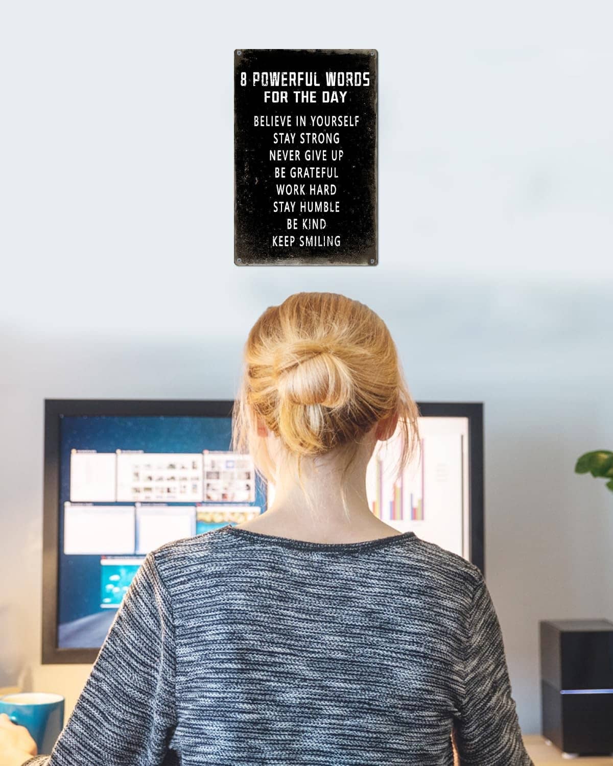 Small black motivational wall sign with 8 phrases mounted on wall