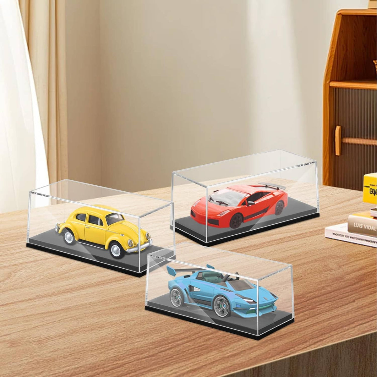 Clear acrylic car display case cubes with dark bases for yellow, red, and blue 1/64 models