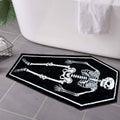 Rectangular black bath mat with white skeleton bones graphic, goth style