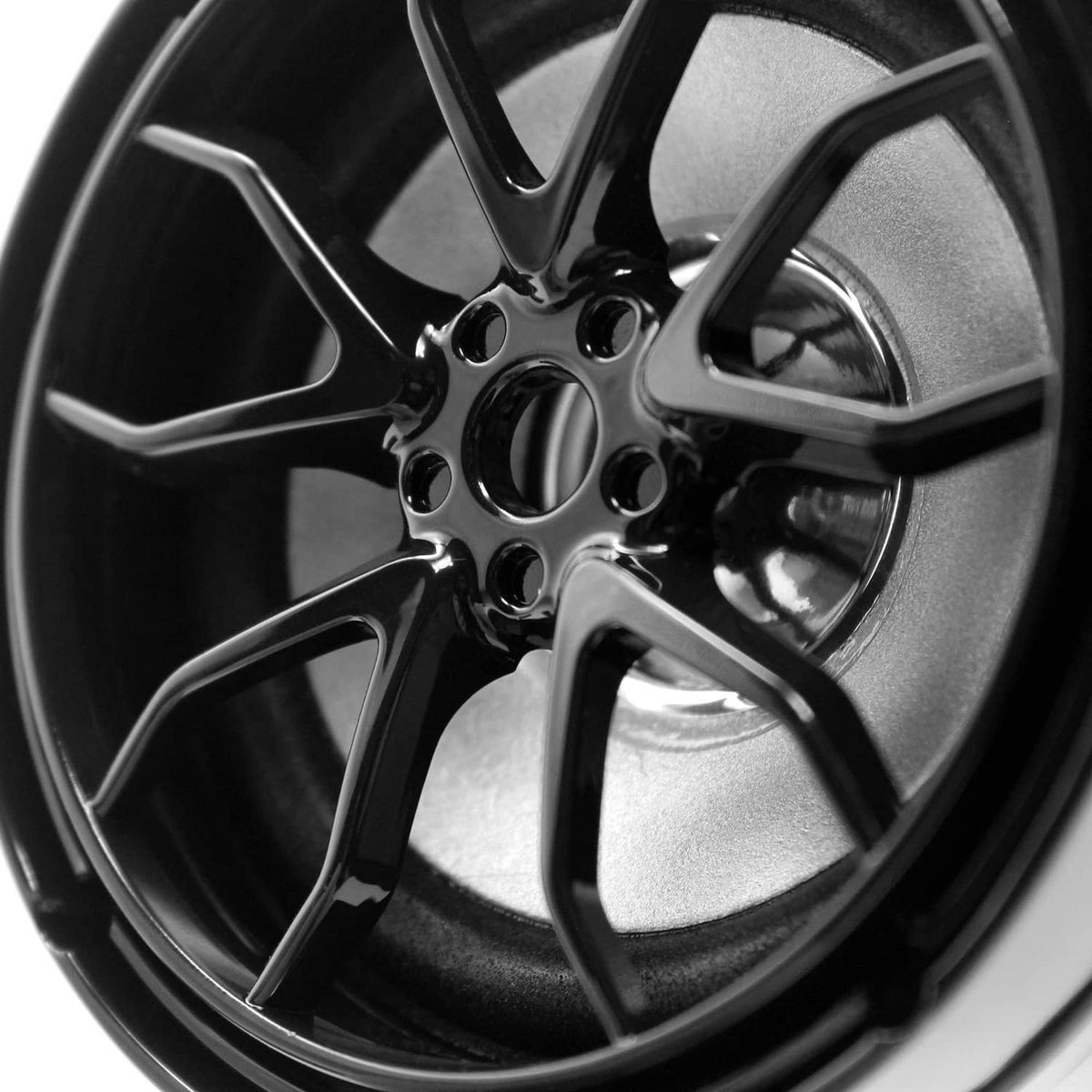 Black motorcycle speaker with circular chrome-like cone and glossy grille detail