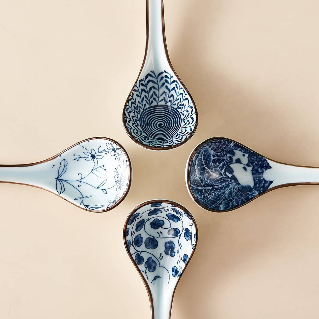 Blue-and-white ceramic soup spoon heads with curved handles, set of four