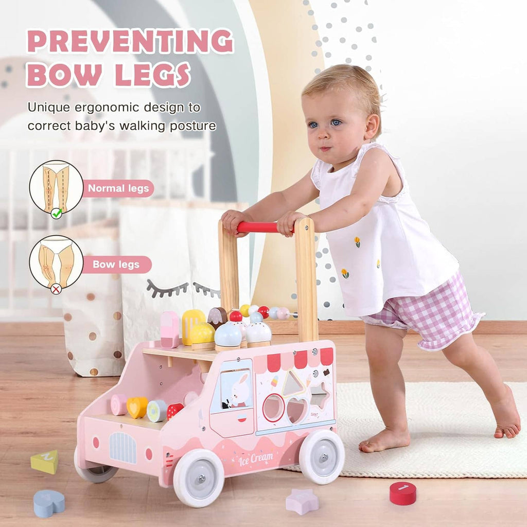 Toddler using pink wooden push walker with red handle, ice-cream toys, and blocks