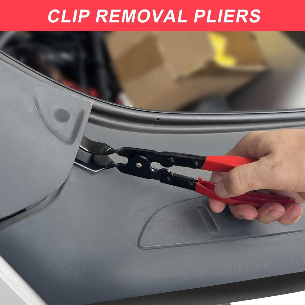 Red and black clip removal pliers pulling a fastener from vehicle trim panel