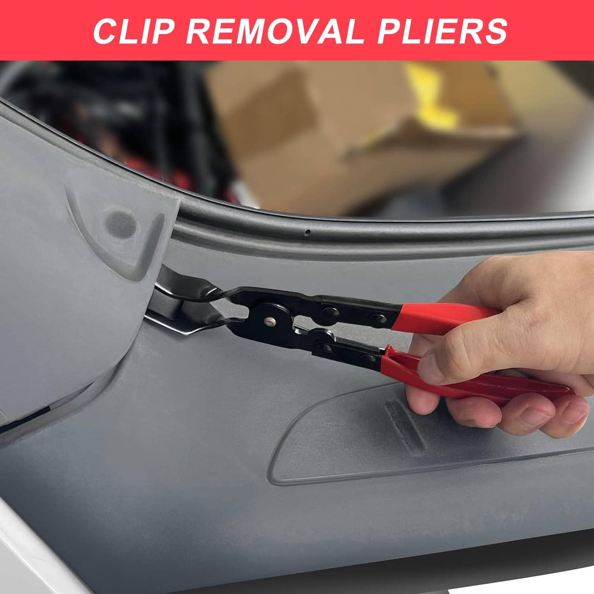 Red and black clip removal pliers pulling a fastener from vehicle trim panel