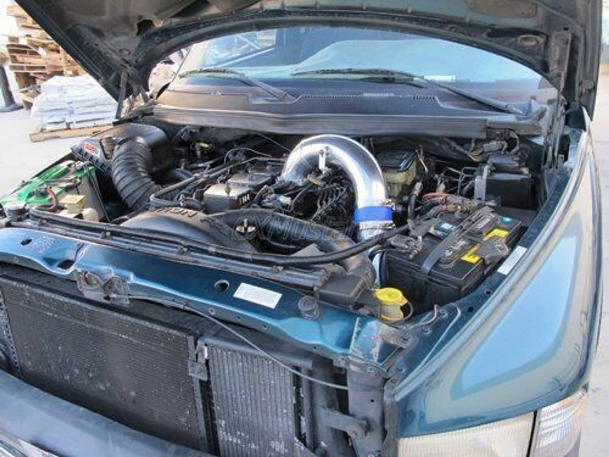 Stainless steel intake elbow pipe with blue coupler installed under hood
