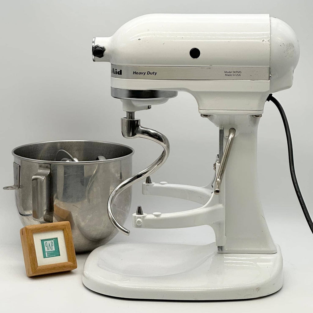 Stainless steel dough hook attachment on white bowl-lift stand mixer