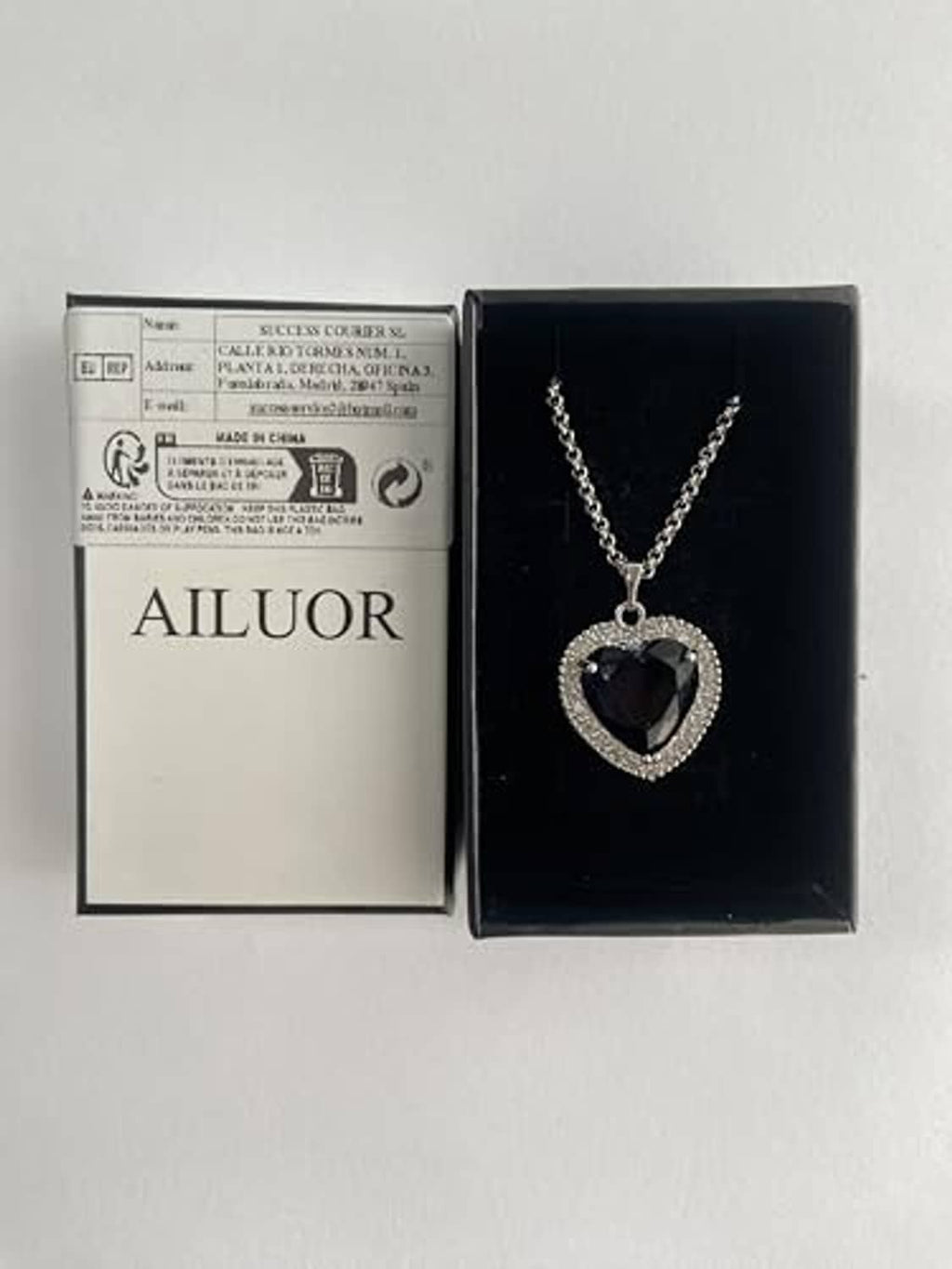 Heart blue pendant necklace set in open box with chain and hanging heart charm