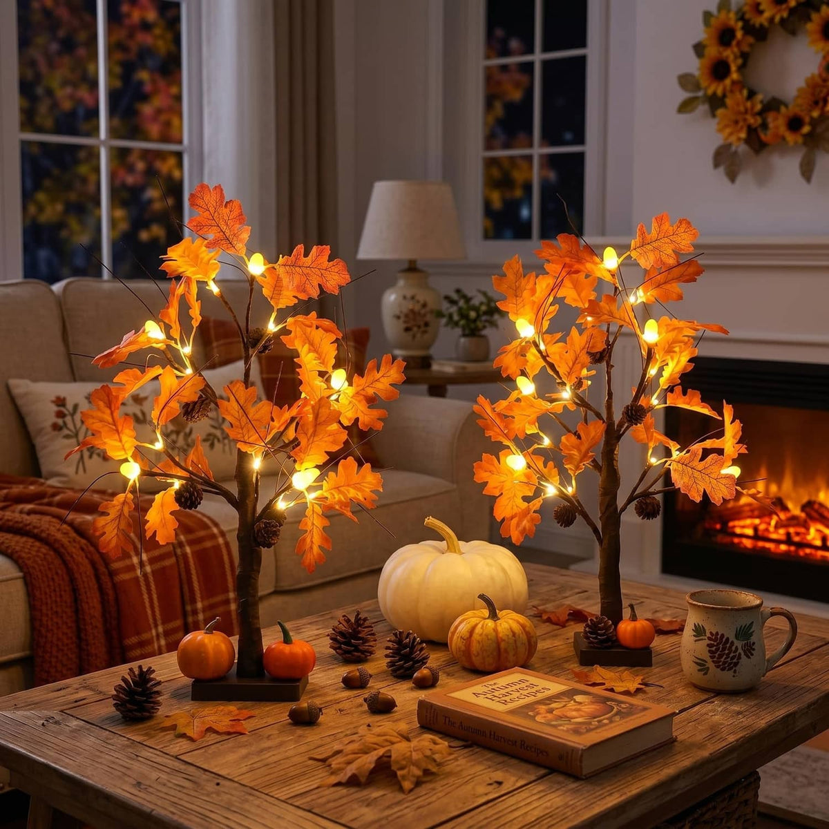 Lighted fall acorn tree decorations with orange leaf lights, on a dining table