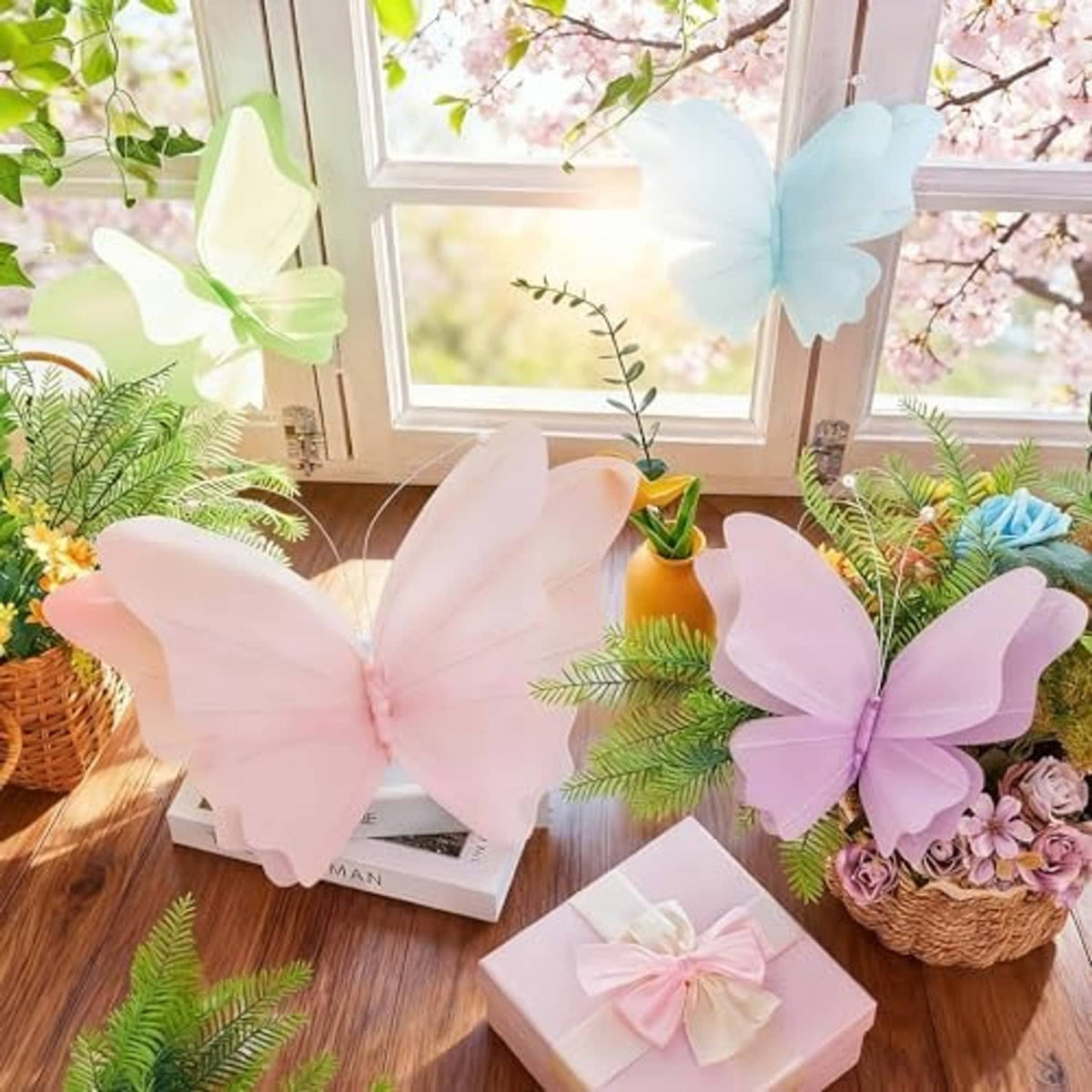 Hanging 3D butterflies in pale pink, lavender, light blue, and mint green with wire antennae