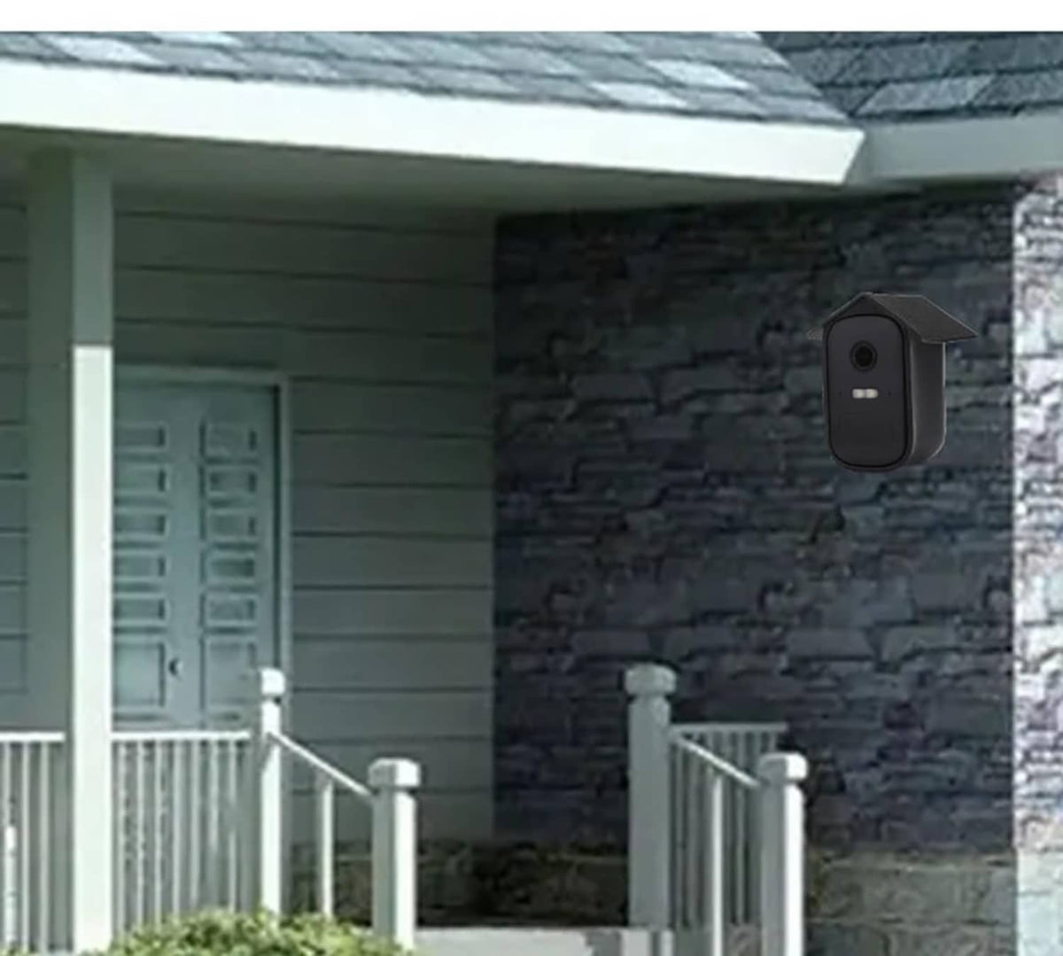 Black silicone camera cover mounted on house wall, open lens and sensor holes