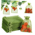 Green mesh drawstring fruit protection bags with strawberry contents