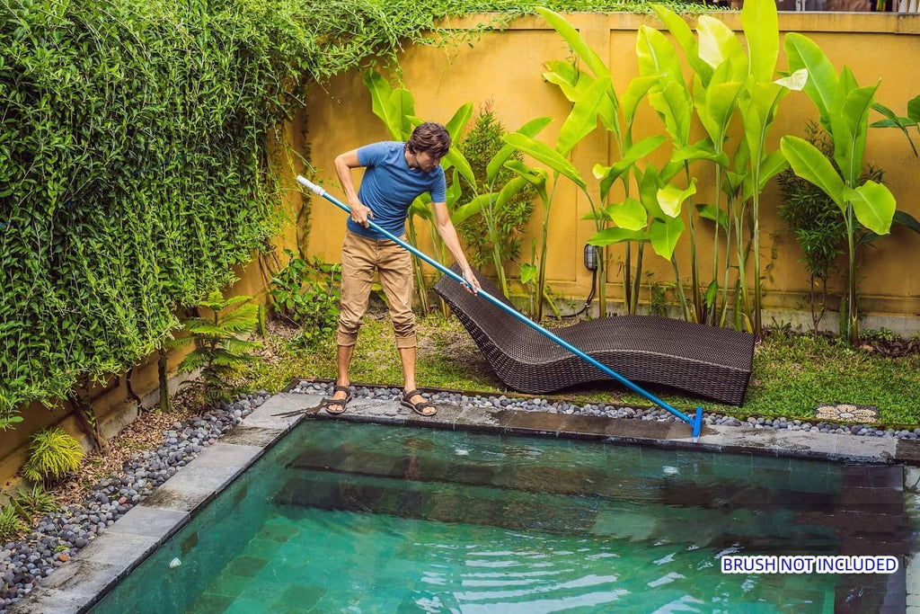 Blue telescopic pool pole angled across the pool during yard maintenance